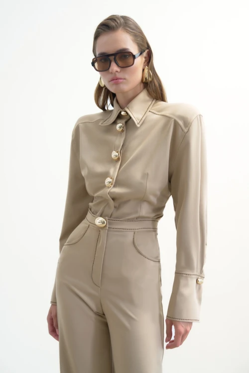 BEIGE TROUSERS WITH GOLD BUTTONS AND BROWN STITCHING DETAIL
