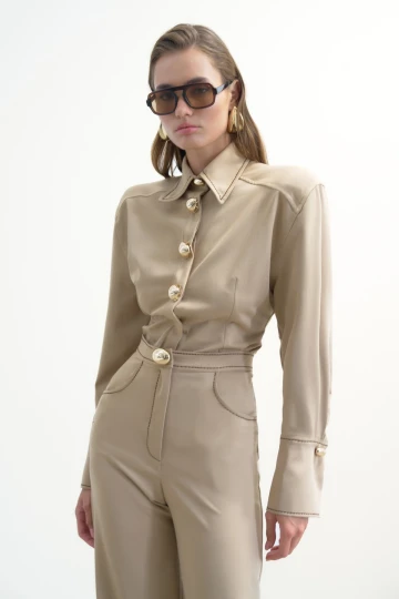 BEIGE TROUSERS WITH GOLD BUTTONS AND BROWN STITCHING DETAIL
